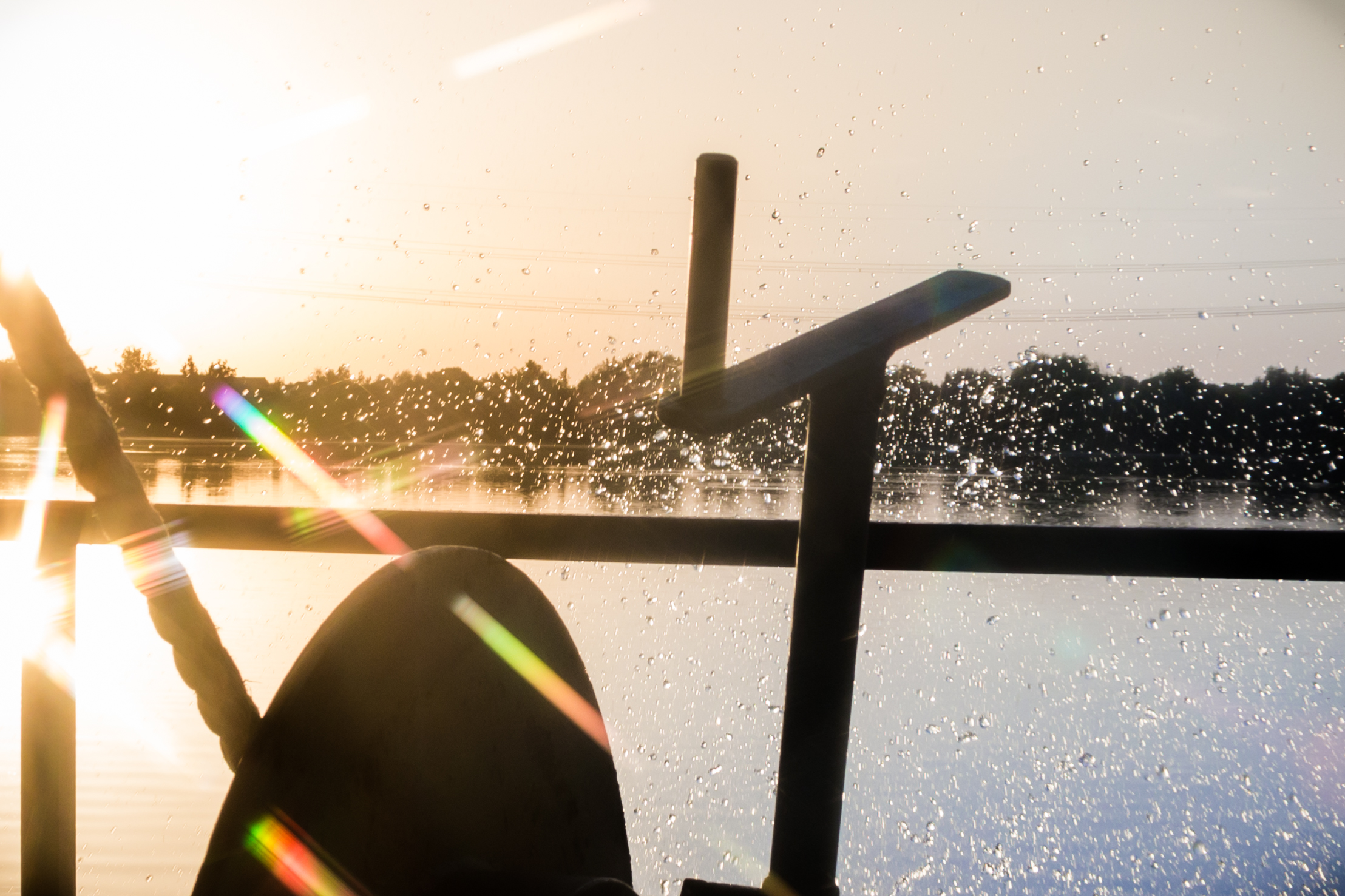 Silhouette of excavator and splashing water at a lake